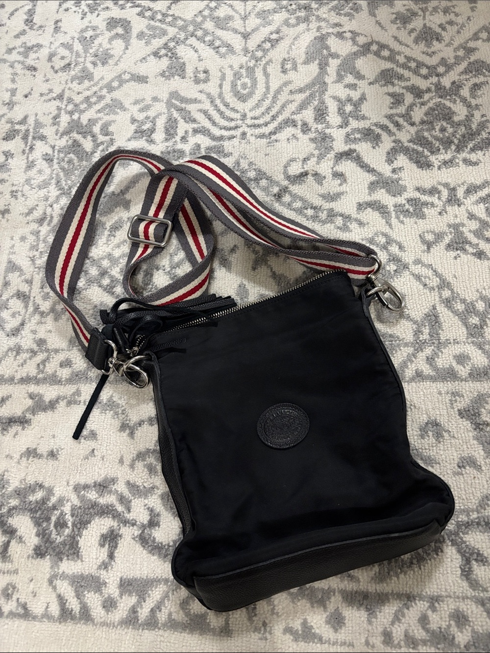 Roots Black Crossbody Bag with Red-White-Gray Striped Strap